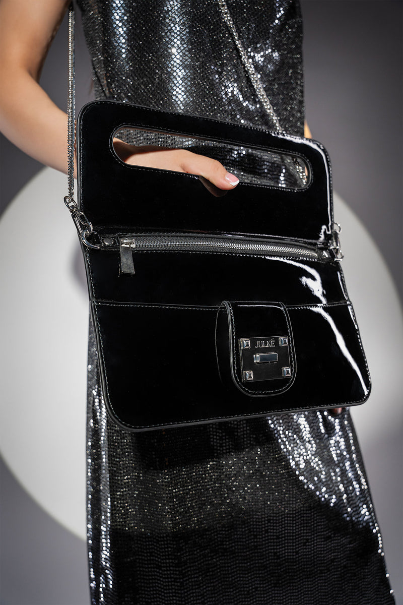 Womens patent leather clutch bag in black colour with twist lock and detachable silver chain strap by JULKE