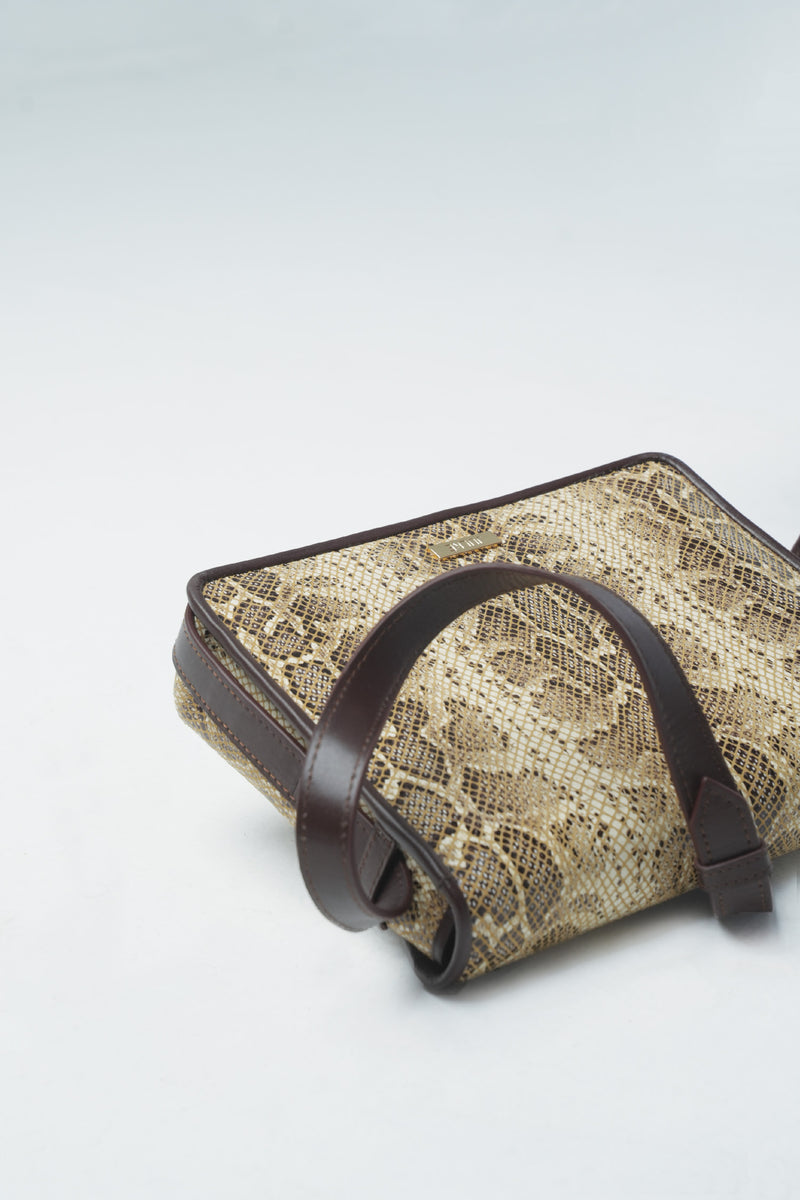 Womens leather shoulder bag in light beige colour with snake print and adjustable shoulder strap by JULKE