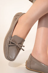 Women's winter leather moccasins in grey colour with glossy finish and leather bow by JULKE