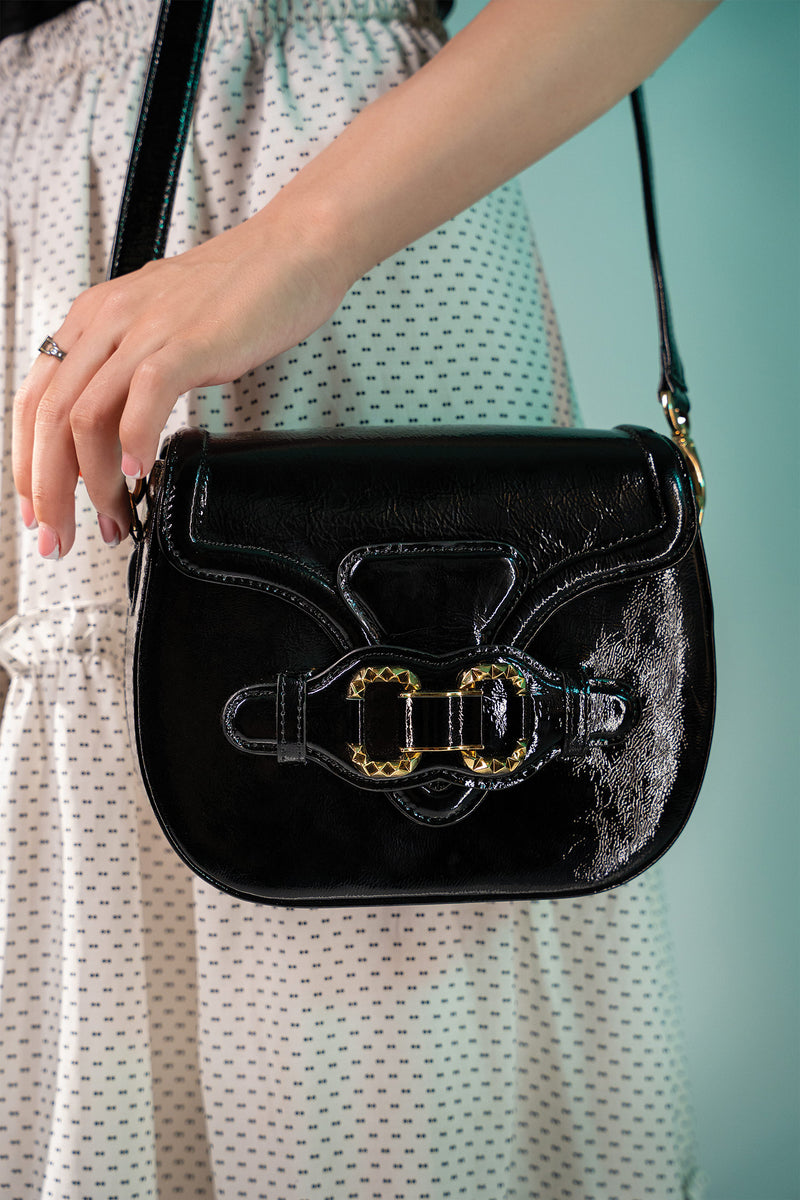 Womens leather shoulder bag in black colour with old horsebit buckle and metallic button flap by JULKE