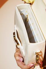 Womens leather shoulder bag in white colour with old horsebit buckle and metallic button flap by JULKE