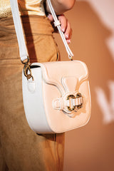 Womens leather shoulder bag in white colour with old horsebit buckle and metallic button flap by JULKE