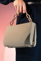 Women's leather top handle bag in grey colour with golden chain handle and textured leather by JULKE