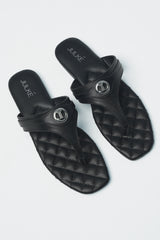 Womens leather flat thongs in black colour with quilted insock and metal logo by JULKE